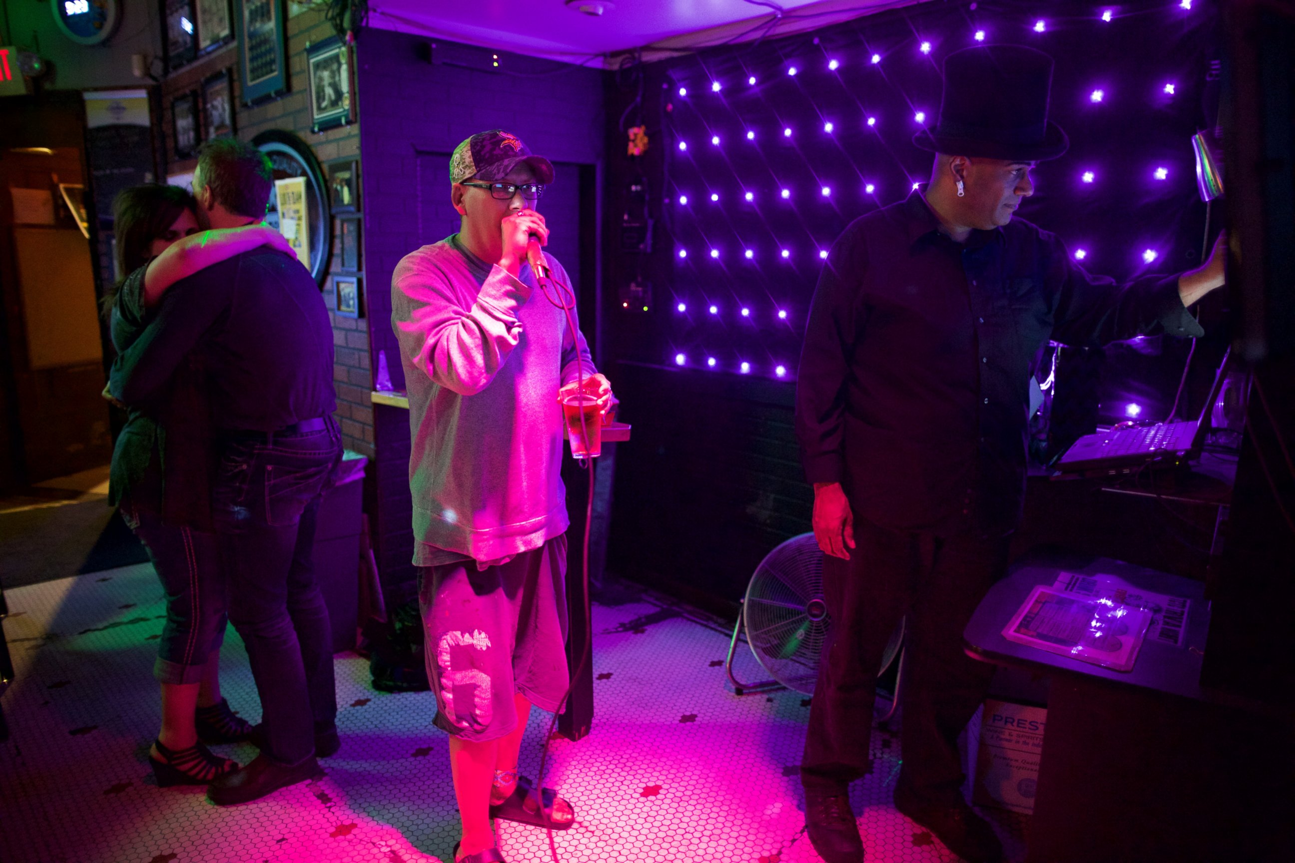 PHOTO: Steve Holum, center, of Minneapolis performs Prince's "Purple Rain" while June Tate and Karlis Nollendorfs, danced in the background. Casey Moo, at right, was the host of the karoke night at Otter's Saloon. 