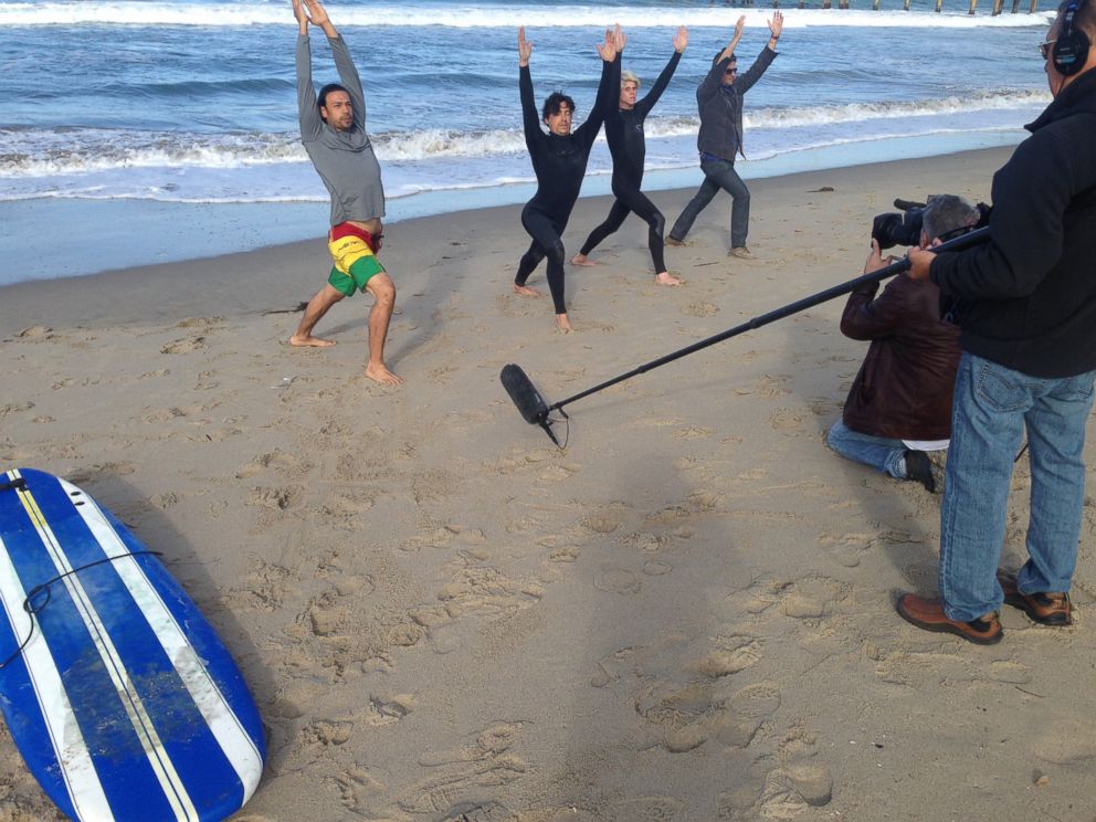 PHOTO: Andrew Keegan, second from the left, is seen here doing yoga before surfing in Venice Beach, California, during an interview with "Nightline."