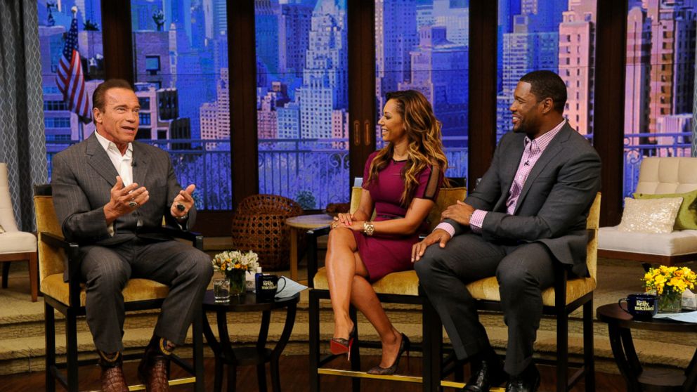 Mel B. and Michael Strahan talk with Arnold Schwarzenegger during "Live! with Kelly and Michael" in New York, March 25, 2014.