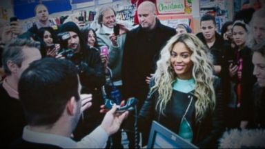 PHOTO: Beyonce dropped into a Walmart store in Tewksbury, Mass. to ambush shocked shoppers and spread some holiday cheer.