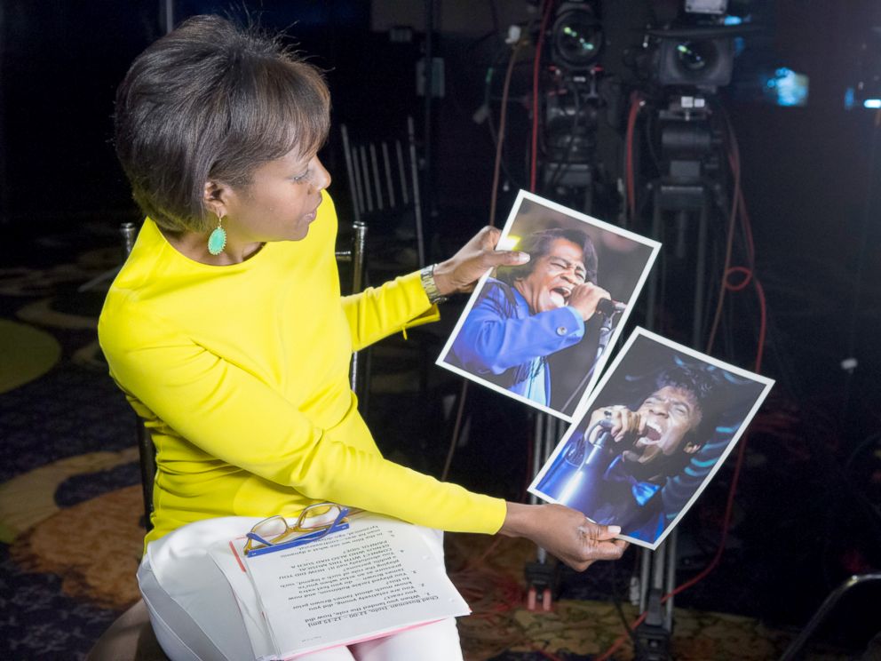 PHOTO: ABCs Deborah Roberts holds a photo of the real James Brown next to a photo of actor Chadwick Boseman playing the music legend in the new biopic, Get On Up.