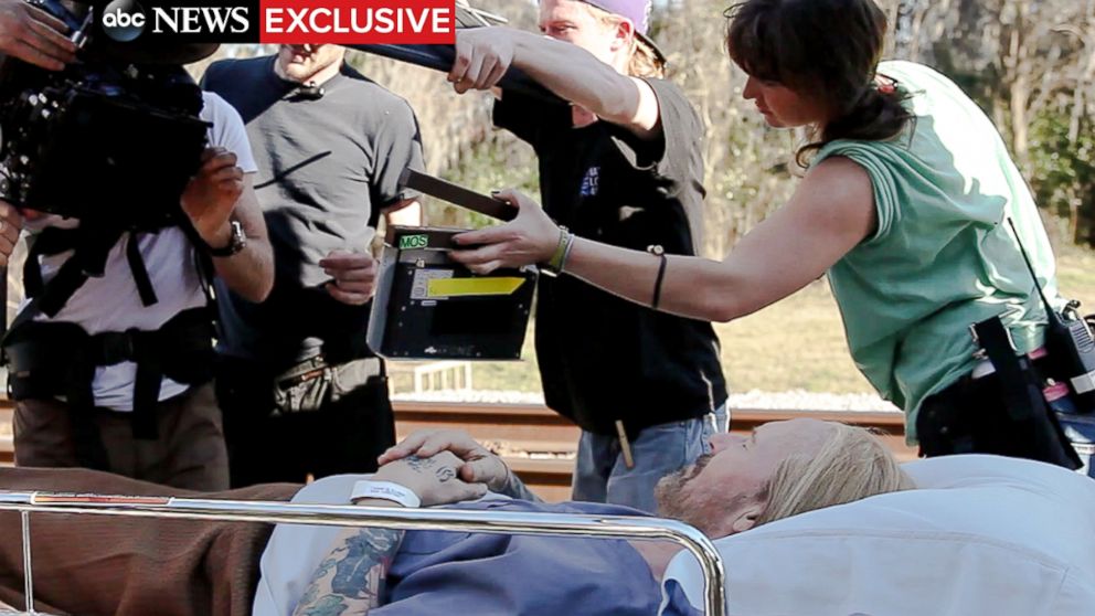PHOTO: Actor William Hurt lays in a hospital bed on the set of "Midnight Rider," just moments before the train accident that killed Sarah Jones, pictured on the far right.