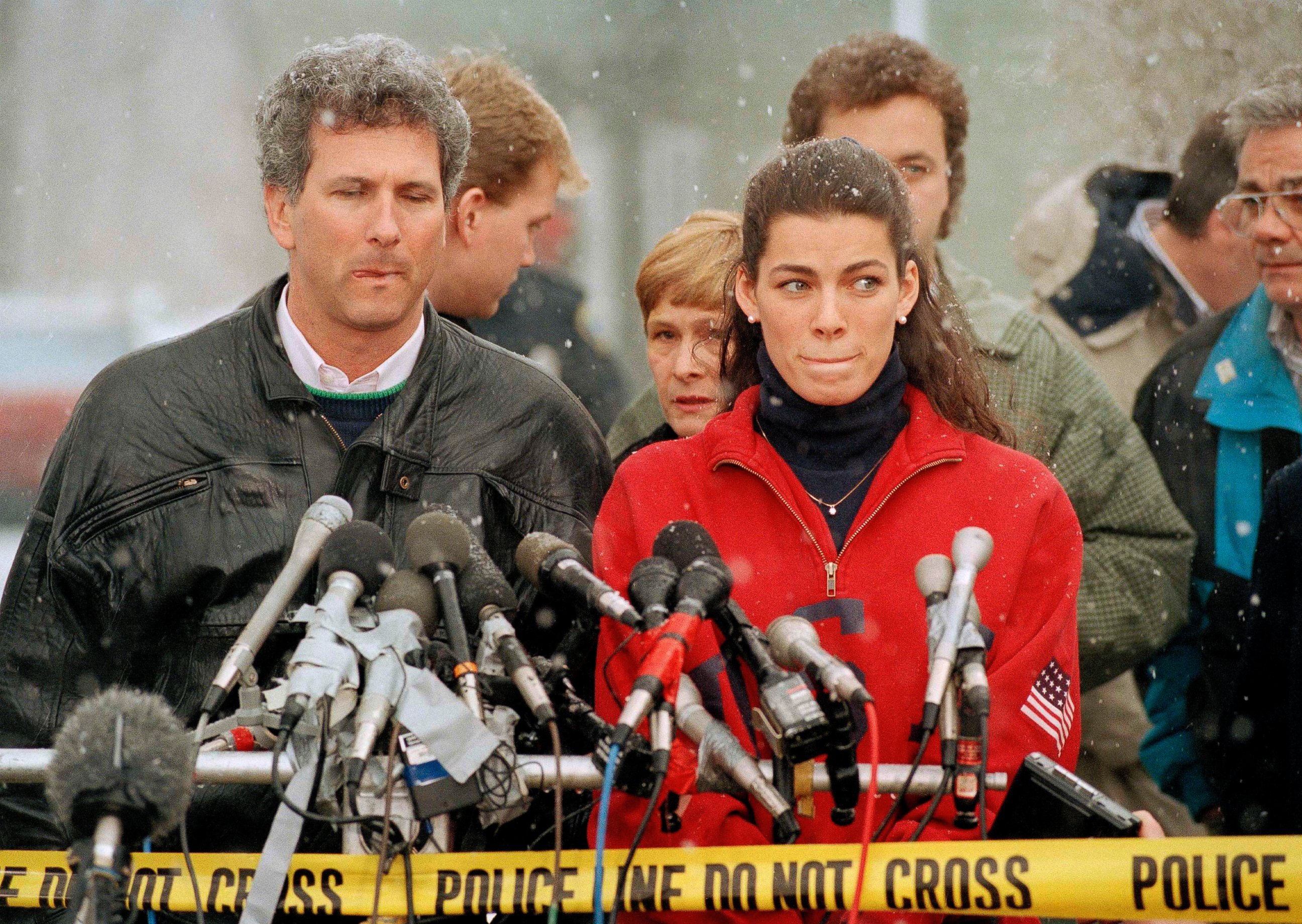 PHOTO: Olympic figure skater Nancy Kerrigan stands at a news conference in Boston, Jan. 14, 1994, as her agent Jerry Solomon, left, looks on. 