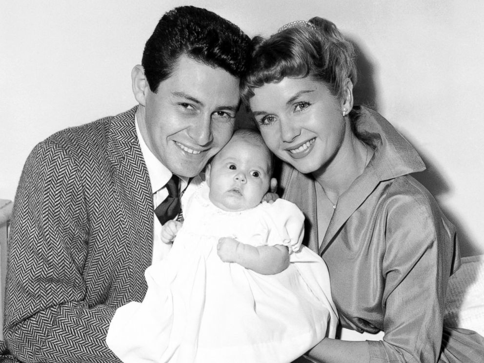 PHOTO: Carrie Fishers parents, Eddie Fisher and Debbie Reynolds, appear before the camera with their daughter to pose for their first family group picture in Hollywood, Jan. 2, 1957.