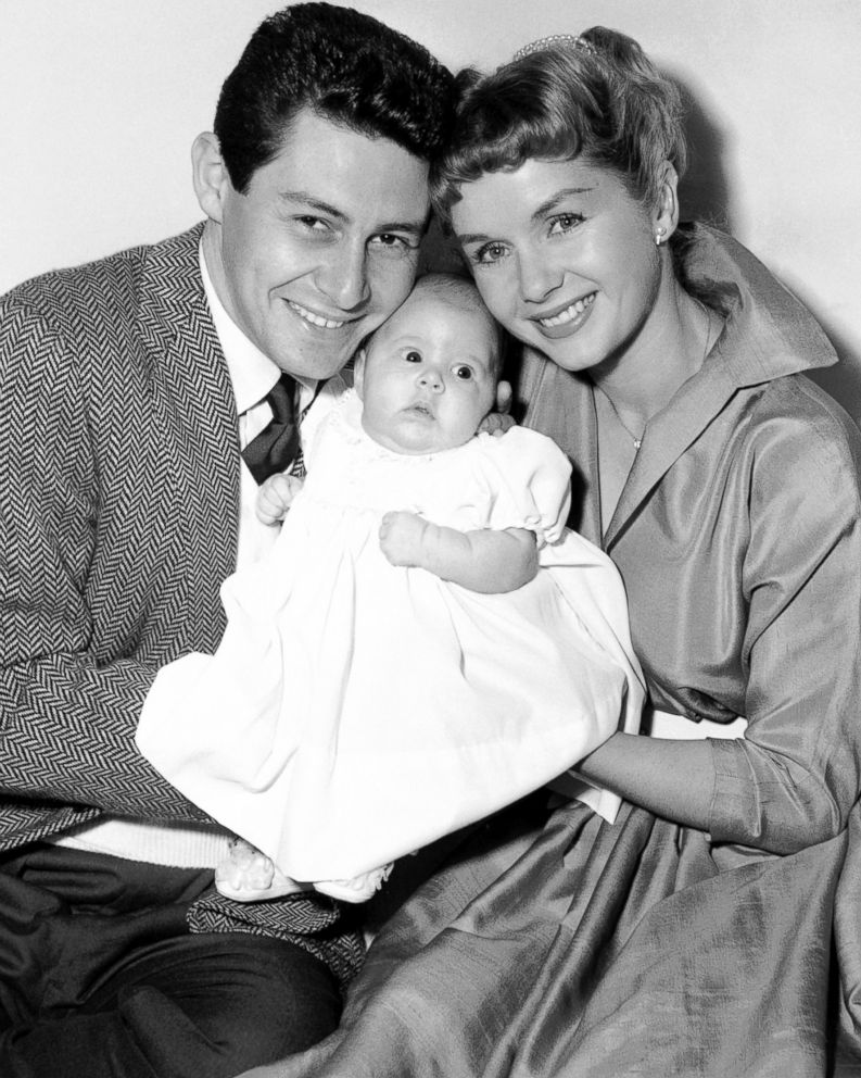 PHOTO: Carrie Fisher's parents, Eddie Fisher and Debbie Reynolds, appear before the camera with their daughter to pose for their first family group picture in Hollywood, Jan. 2, 1957. 