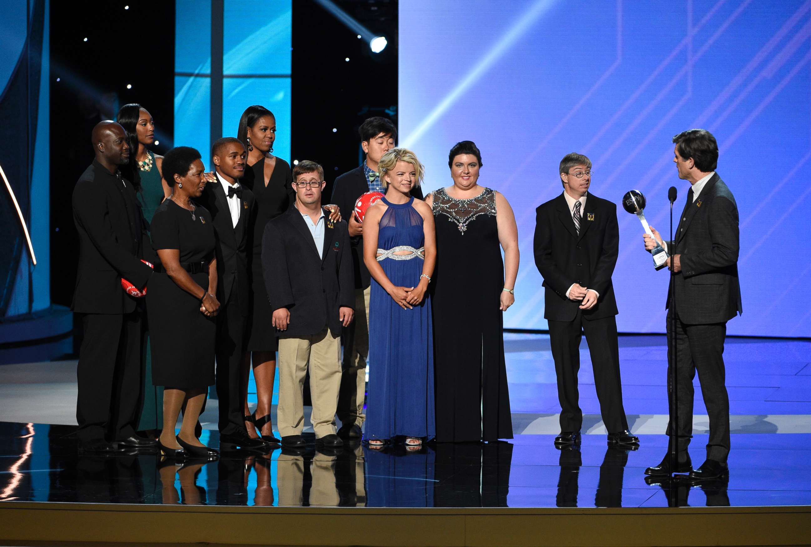 PHOTO: Timothy Shriver addresses former first lady Michelle Obama, fifth from left, and Special Olympic athletes as he accepts the Arthur Ashe Courage Award on behalf of his late mother at the Microsoft Theater, July 12, 2017, in Los Angeles.