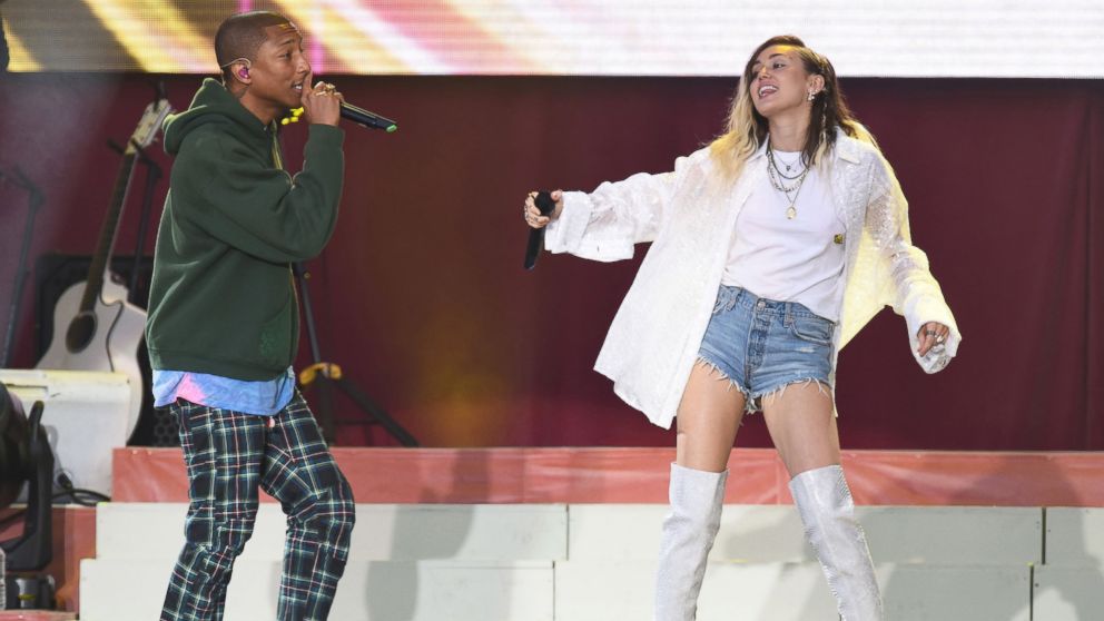 Singers Pharrell Williams, left, and Miley Cyrus perform at the One Love Manchester tribute concert in Manchester, north western England, June 4, 2017.