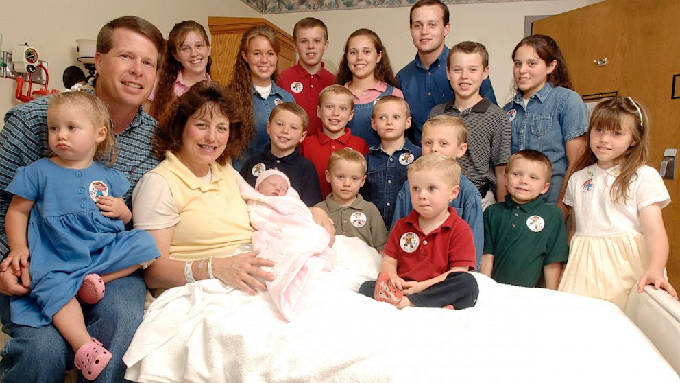 Michelle Duggar, left, is surrounded by her children and husband Jim Bob, after the birth of her 17th child in Rogers, Ark.