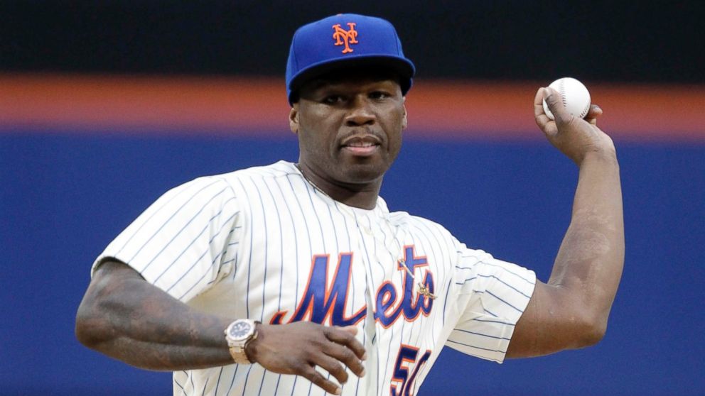 Rapper 50 Cent throws out the ceremonial first pitch before a baseball game between the New York Mets and the Pittsburgh Pirates, May 27, 2014, in New York.