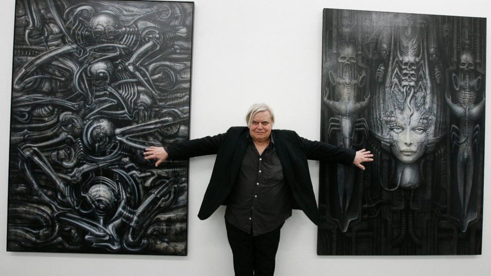 In this June 29, 2007 file picture  Swiss artist H.R. Giger  poses with two of his works at the art museum in Chur, Switzerland.  