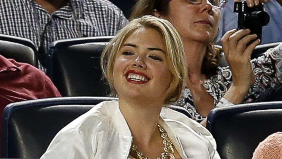 Supermodel Kate Upton smiles as she sits in the seats above the Detroit Tigers dugout in a baseball game between the Tigers and the New York Yankees at Yankee Stadium in New York, Aug. 4, 2014.