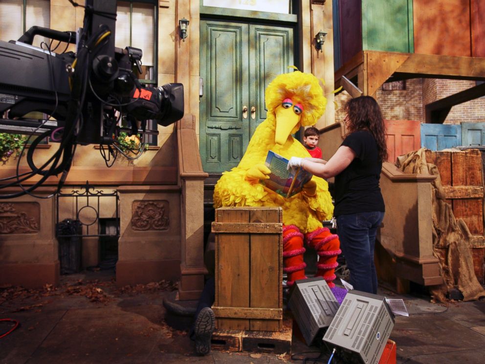 PHOTO: Michelle Hickey, a Muppet wrangler adjusts a book for Big Bird, voiced by Carroll Spinney, so he can read to Connor Scott during a taping of Sesame Street in New York, April 10, 2008.