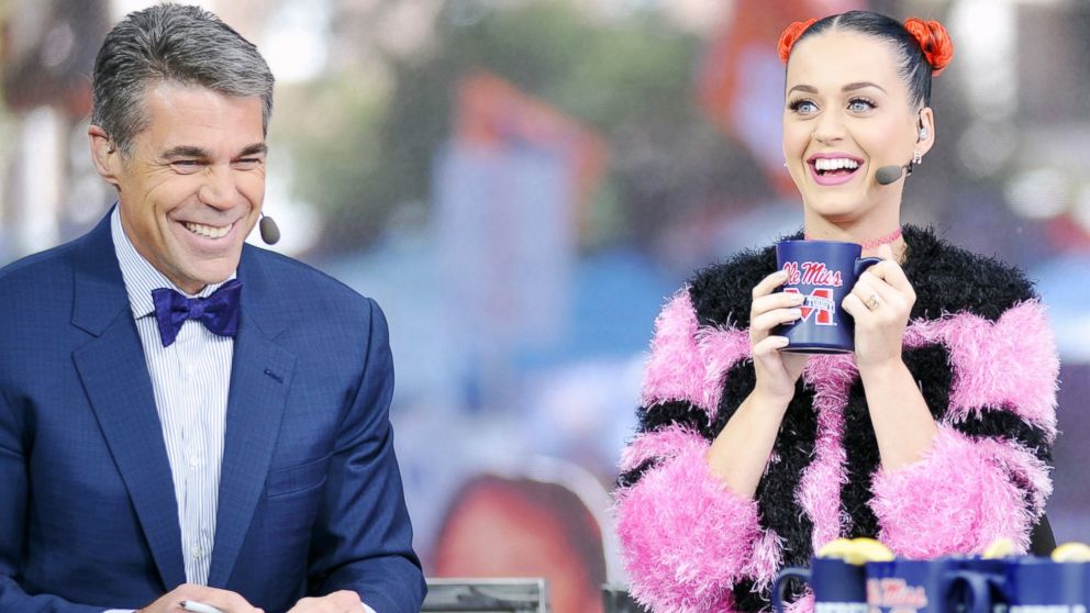 Katy Perry, right, joins host Chris Fowler, left, during telecast of ESPN's College GamDay in The Grove at the University of Mississippi prior to their NCAA college football game in Oxford, Miss., Oct. 4, 2014.