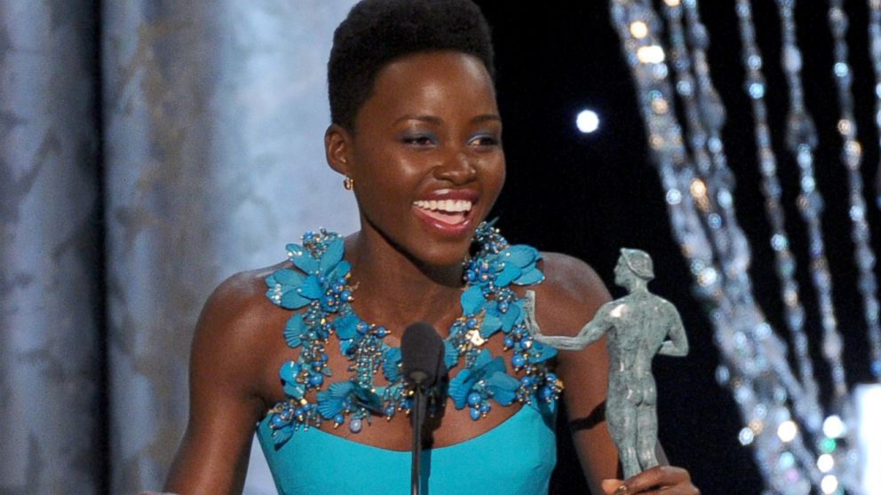Lupita Nyong'o accepts an award for her role in "12 Years a Slave" at the 20th annual SAG Awards, Jan. 18, 2014, in Los Angeles. 