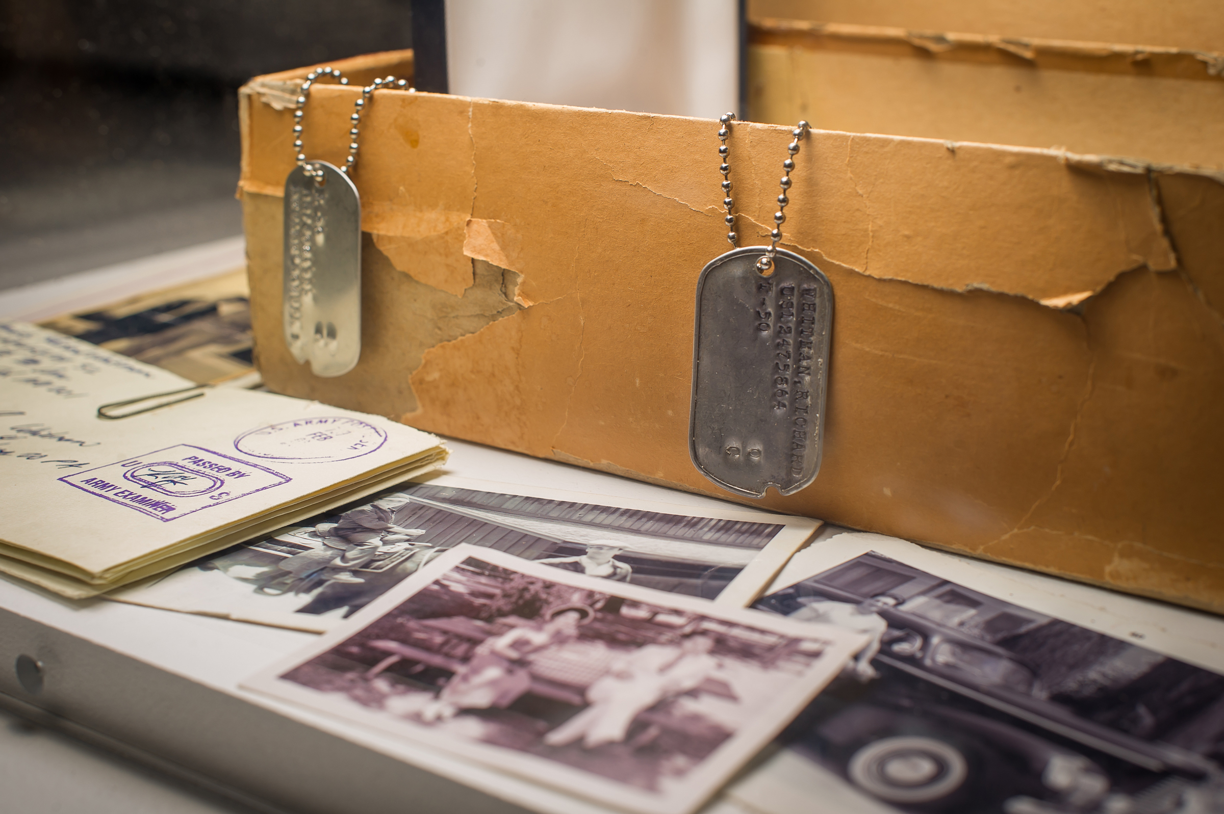 PHOTO: In this March 10, 2015, photo, character Don Draper's box of secrets, including Dick Whitman's dog tag, letters and family photos are displayed as part of the exhibition, "Matthew Weiner's Mad Men," at the Museum of the Moving Image in New York.