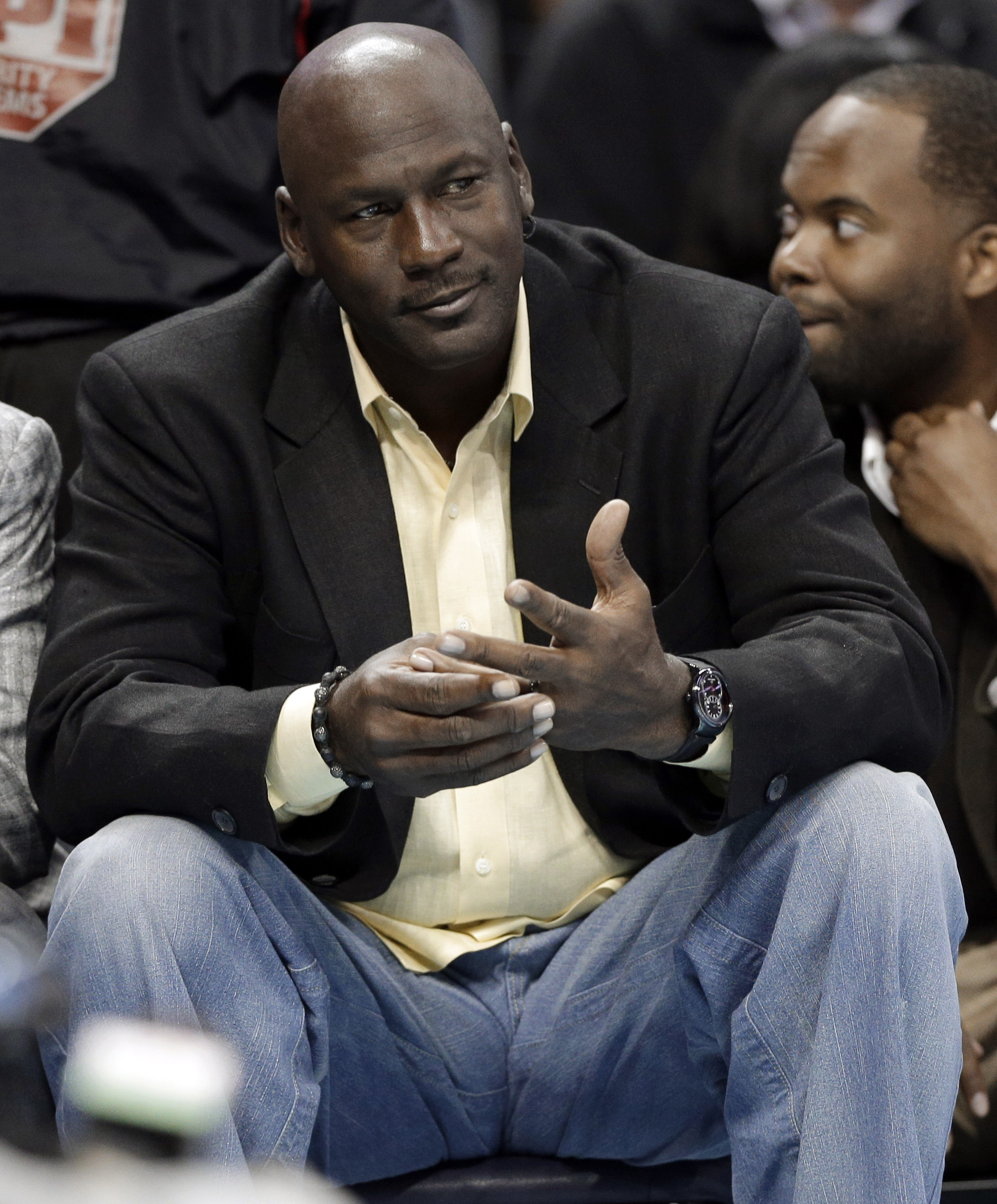 PHOTO:  Michael Jordan watches during the first half of an NBA basketball game between the Charlotte Bobcats and the Chicago Bulls in Charlotte, N.C., April 16, 2014. 