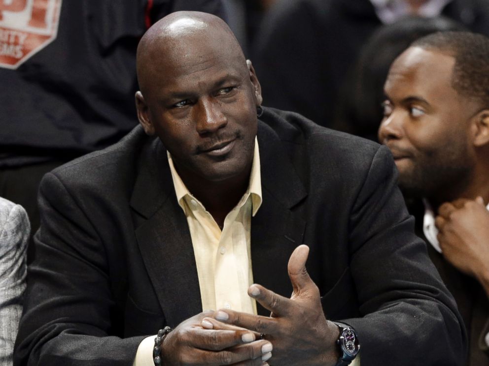 PHOTO: Michael Jordan watches during the first half of an NBA basketball game between the Charlotte Bobcats and the Chicago Bulls in Charlotte, N.C., April 16, 2014.