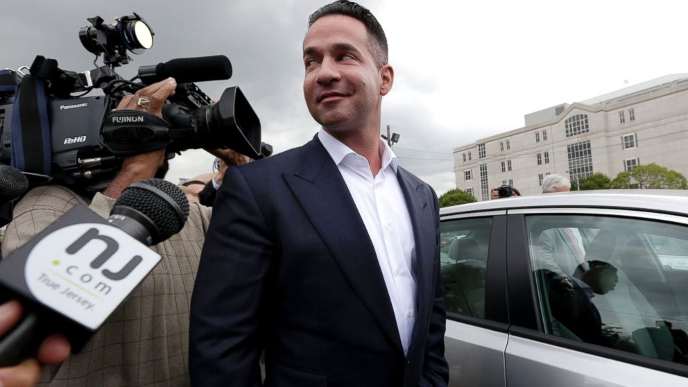 Reporters gather around Mike "The Situation" Sorrentino as he leaves the MLK Jr. Federal Courthouse in Newark, New Jersey, after a court appearance, Sept. 24, 2014. 