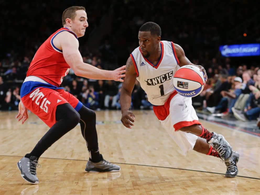 PHOTO: Kevin Hart, right, drives past Robert Pera, left, during the second half of the NBA All-Star celebrity basketball game Friday, Feb. 13, 2015, in New York. 