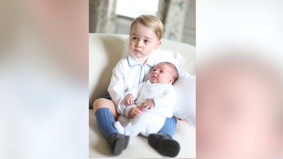 PHOTO: Britain's Princess Charlotte, right, being held by her brother, 2-year-old, Prince George.