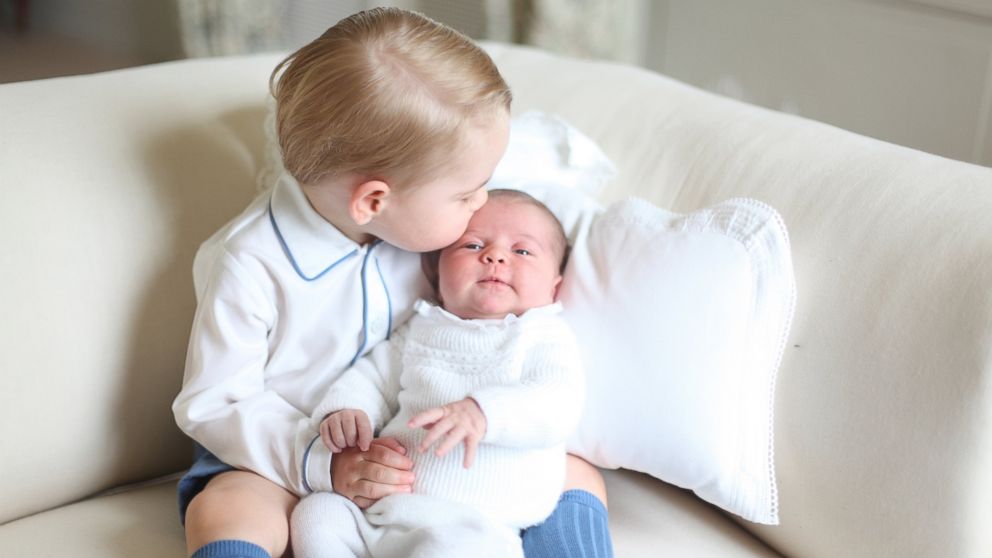 PHOTO: Britain's Princess Charlotte, right, being held by her brother, 2-year-old, Prince George.