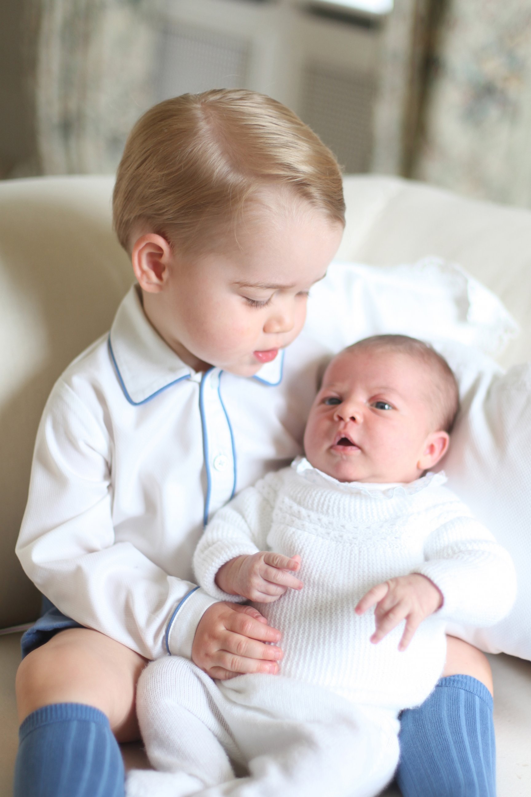 PHOTO: Britain's Princess Charlotte, right, being held by her brother, 2-year-old, Prince George. 