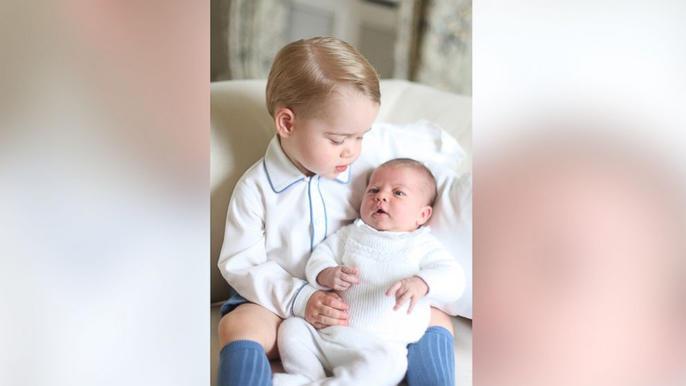 PHOTO: Britain's Princess Charlotte, right, being held by her brother, 2-year-old, Prince George. 