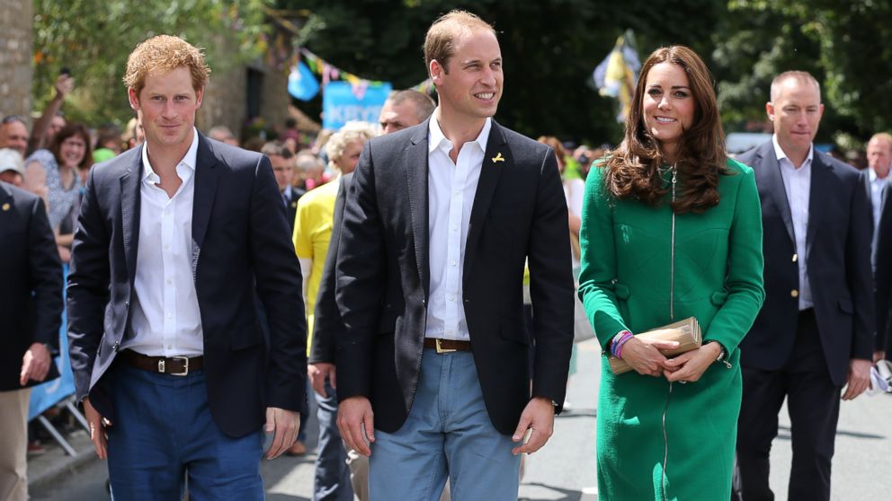 PHOTO: (L-R) Prince Harry, Prince William and Kate, Duchess of Cambridge walk along the street to celebrate the start of the Tour de France in Yorkshire at West Tanfield, England, Saturday, July 5, 2014.