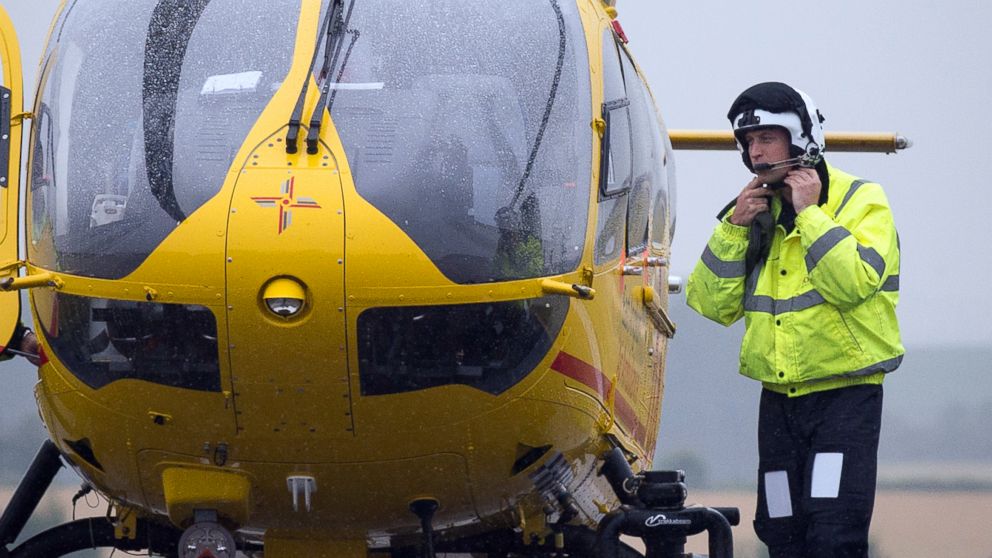 Britain's Prince William, the Duke of Cambridge adjusts his helmet as he prepares to board an East Anglian Air Ambulance (EAAA),  to begin his new job,  at Cambridge Airport, Cambridge, in England,July 13, 2015.