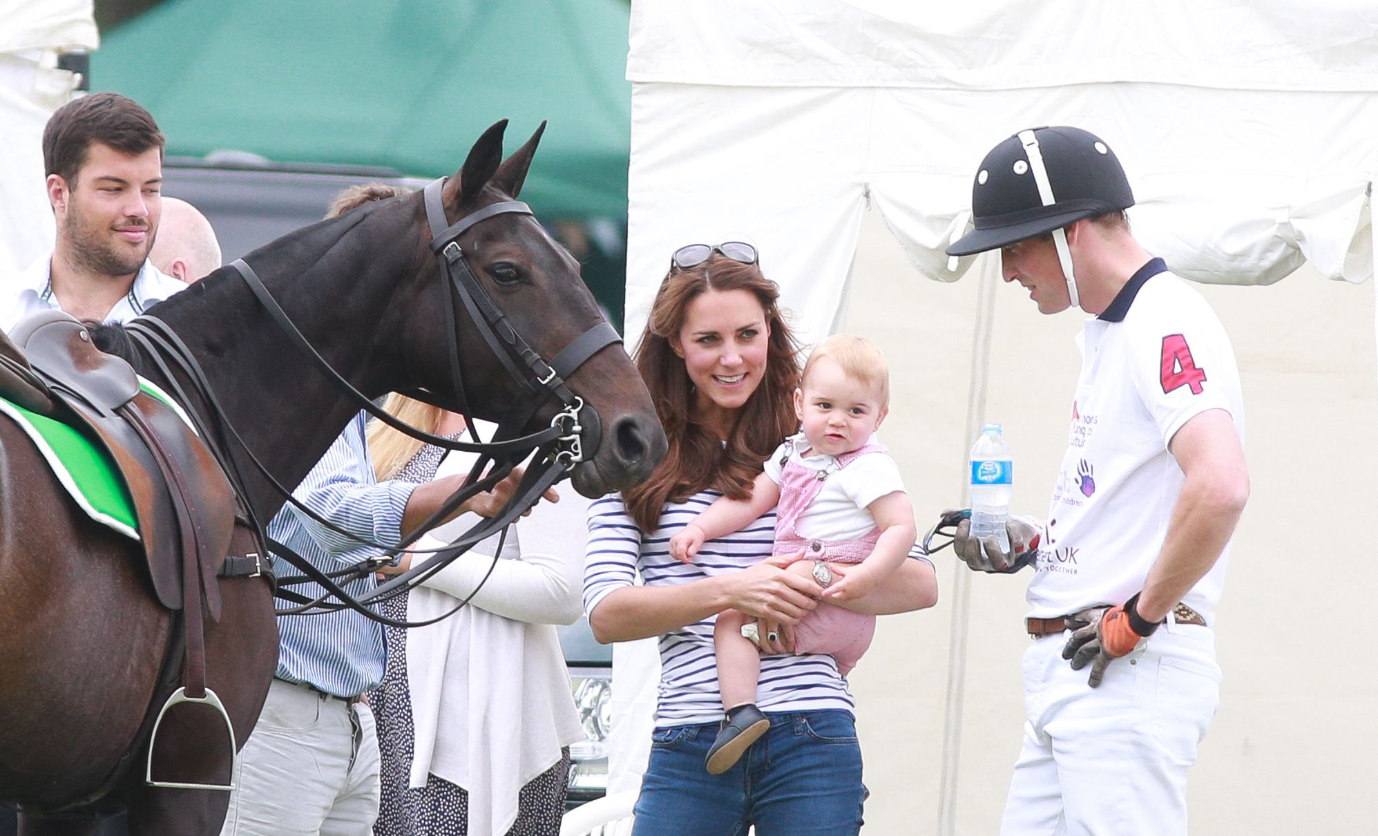 PHOTO: Prince William, Catherine Duchess of Cambridge and Prince George attend the
Jerudong Trophy polo match at the Cirencester Polo Club in Gloucestershire, England, June 15, 2014.
