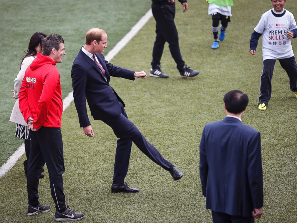PHOTO: Britains Prince William, center, kicks a ball as he attends the Premier Skills football coaching event at Nanyang Secondary School in Shanghai, March 3, 2015.