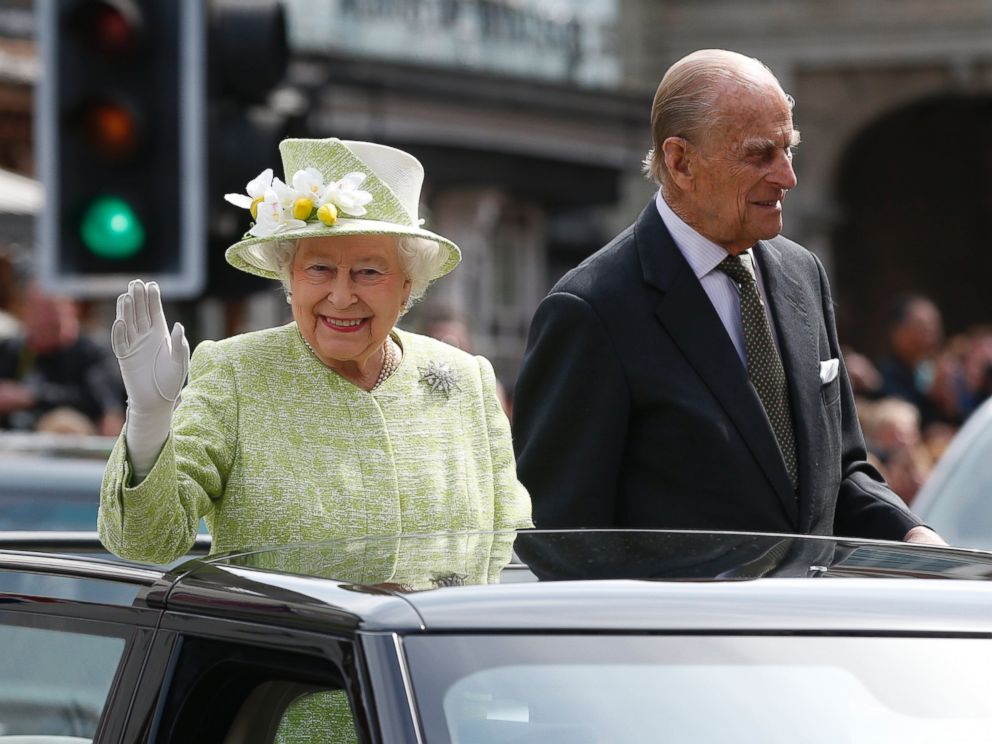 PHOTO: Queen Elizabeth II waves to the crowds as she rides with Prince Phillip in a open top car to celebrates her 90th birthday in Windsor, Britain, April, 21, 2016.