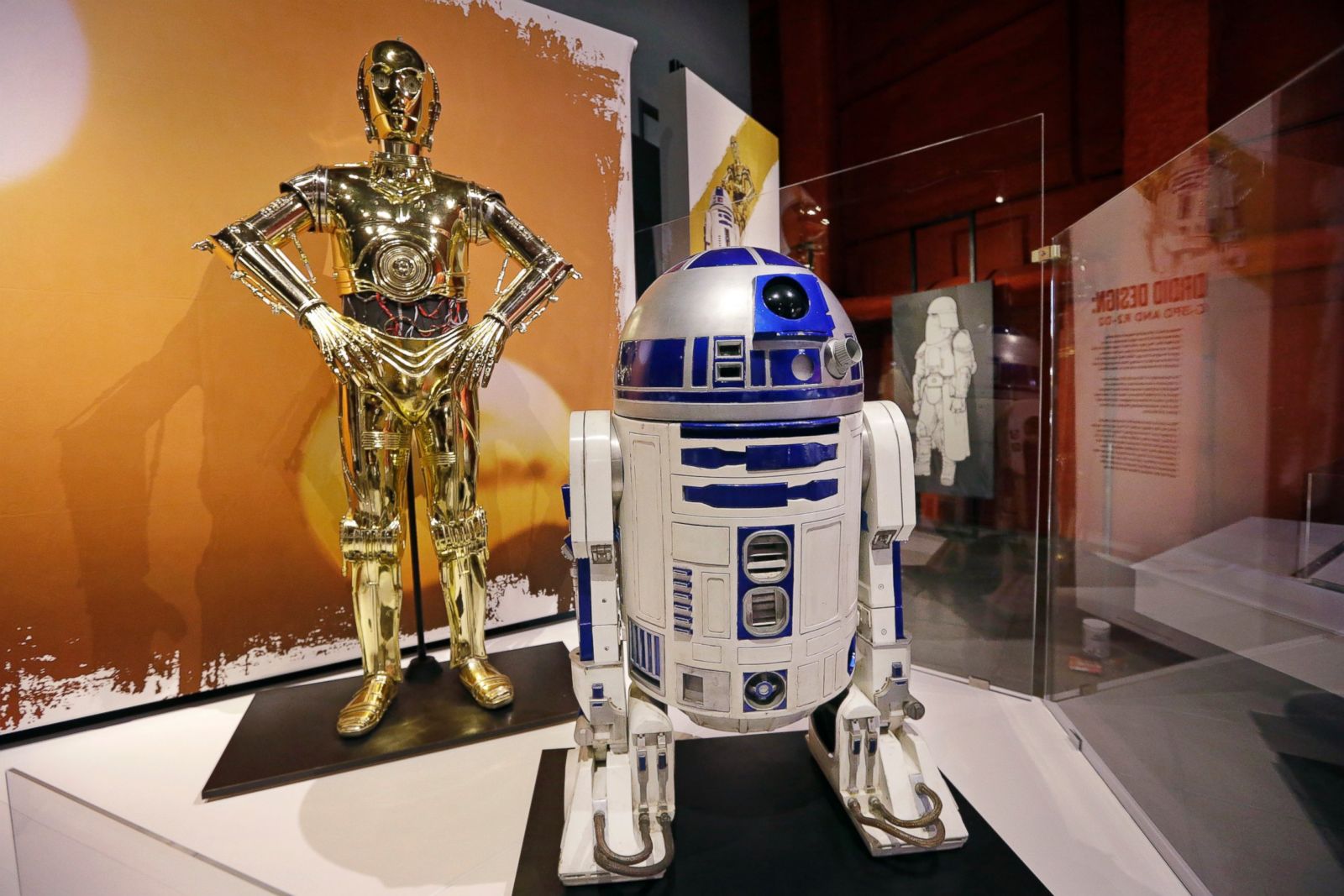 View C-3PO, left, and R2-D2 costumes are displayed as part of an exhibit on...