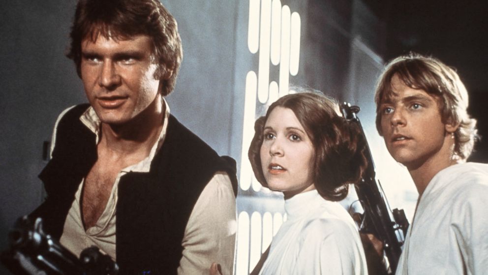 From left, Harrison Ford, Carrie Fisher and Mark Hamill are pictured in a scene from "Star Wars" in 1977.