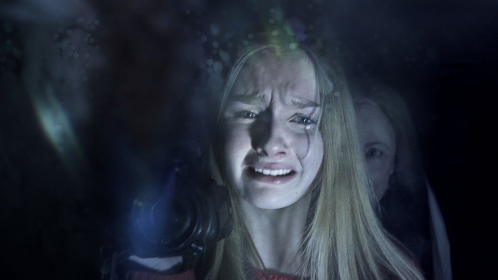 In this image released by Universal Pictures, Olivia DeJonge, foreground, and Deanna Dunagan appear in a scene from "The Visit." 