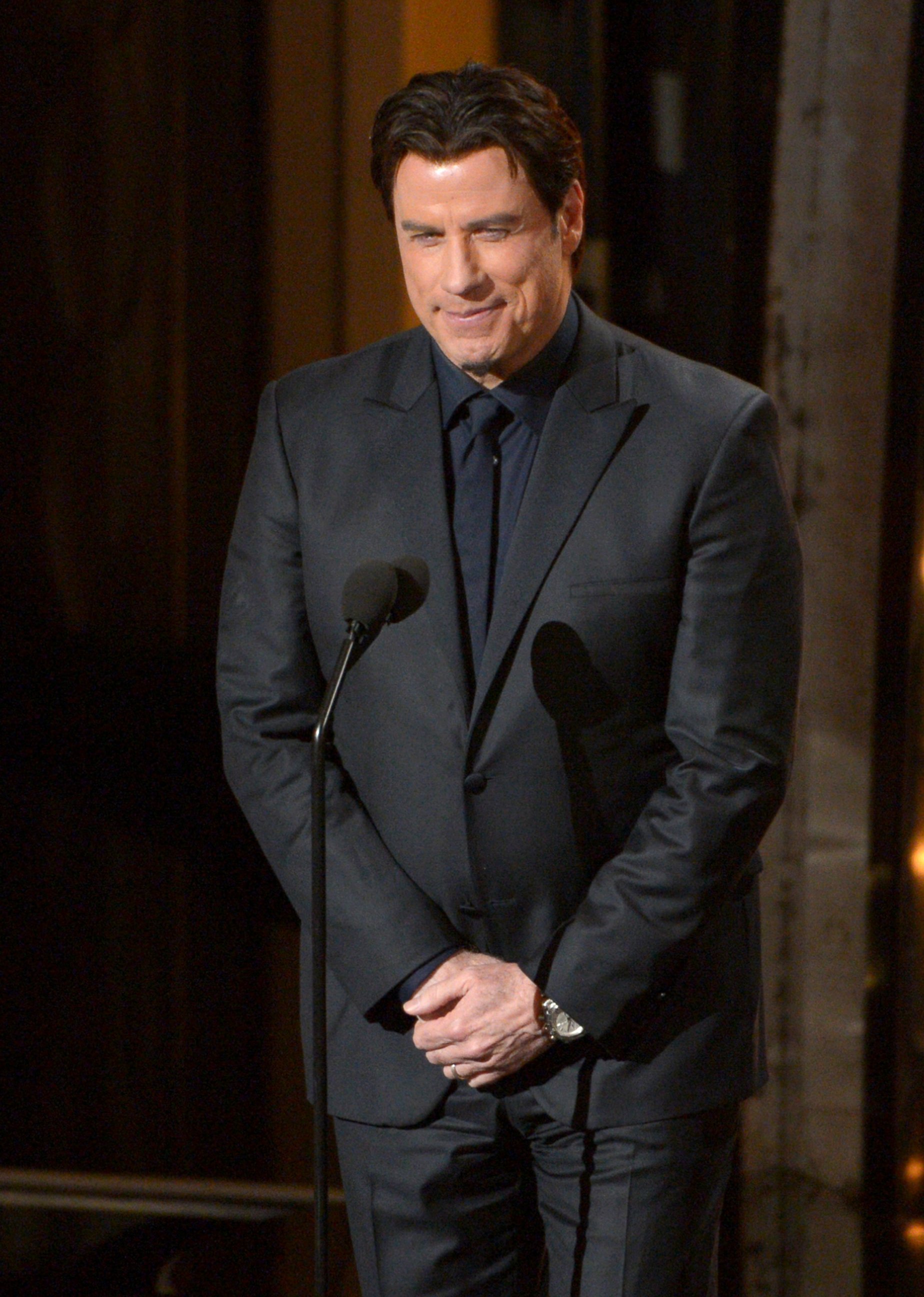 PHOTO: John Travolta speaks during the Oscars at the Dolby Theatre, March 2, 2014 in Los Angeles.