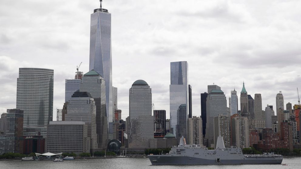 The USS San Antonio passes by One World Trade Center in lower Manhattan, May 20, 2015, in New York.