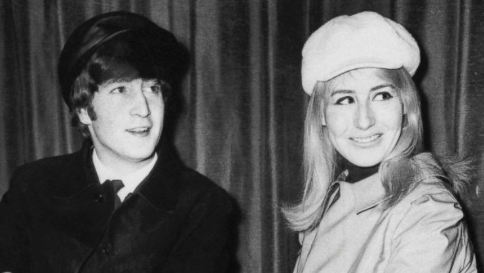 John Lennon, left, and his wife Cynthia, a former art student, wait for a plane at London Airport, Feb. 26, 1966.