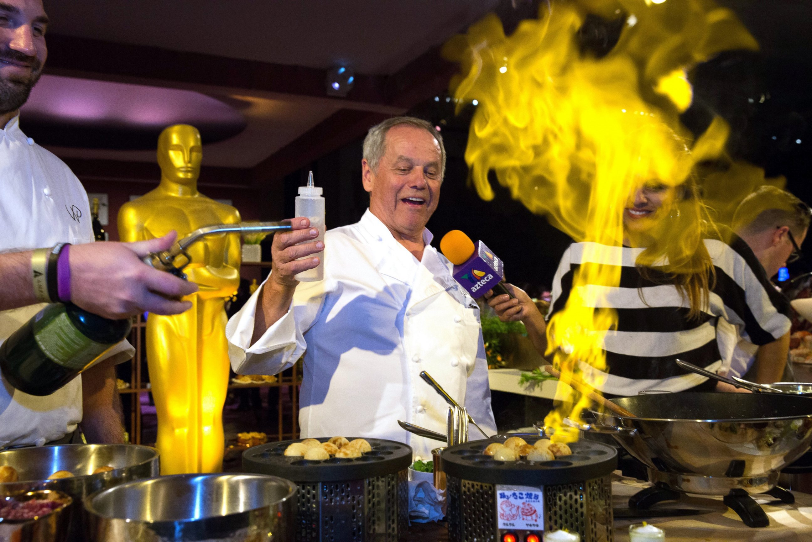 PHOTO: Wolfgang Puck, center, lights up a specialty donut during the press preview of the 88th Oscars Governors Ball in Hollywood, Calif., Feb. 18, 2016. The event is the official post-Oscars celebration that will take place on Feb. 28. 