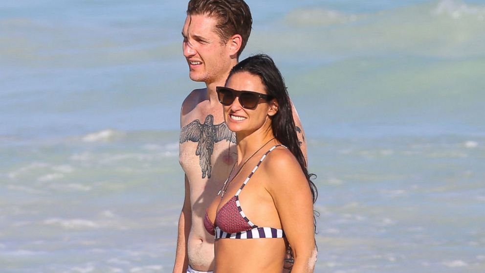 Demi Moore and her new boyfriend Sean Friday walk on the beach while on vacation with her daughter Rumer and other family members in Mexico, Dec. 30, 2013.