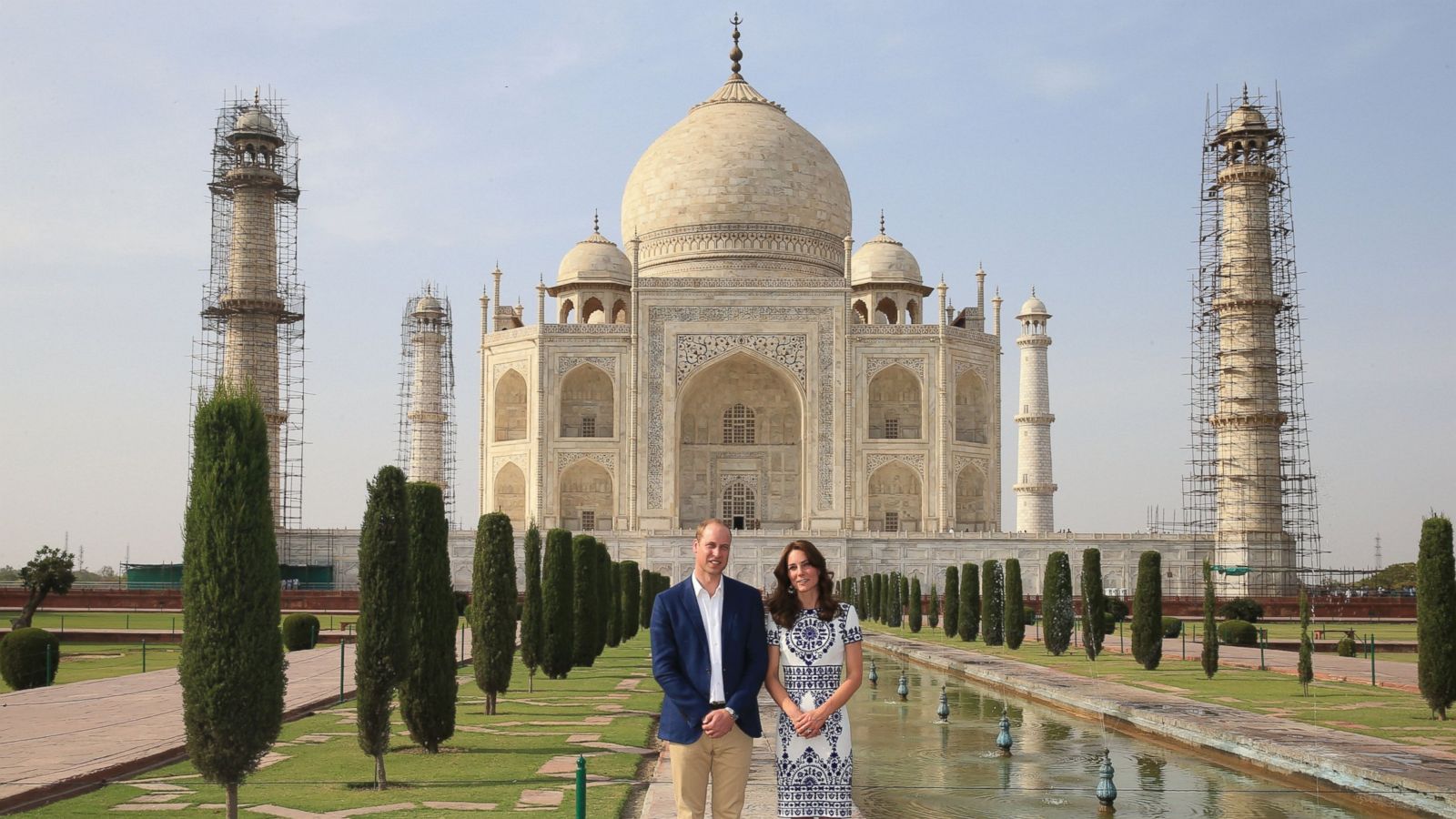 Young indian female tourist posing in front of taj mahal. posing • wall  stickers earth, wonder, woman | myloview.com