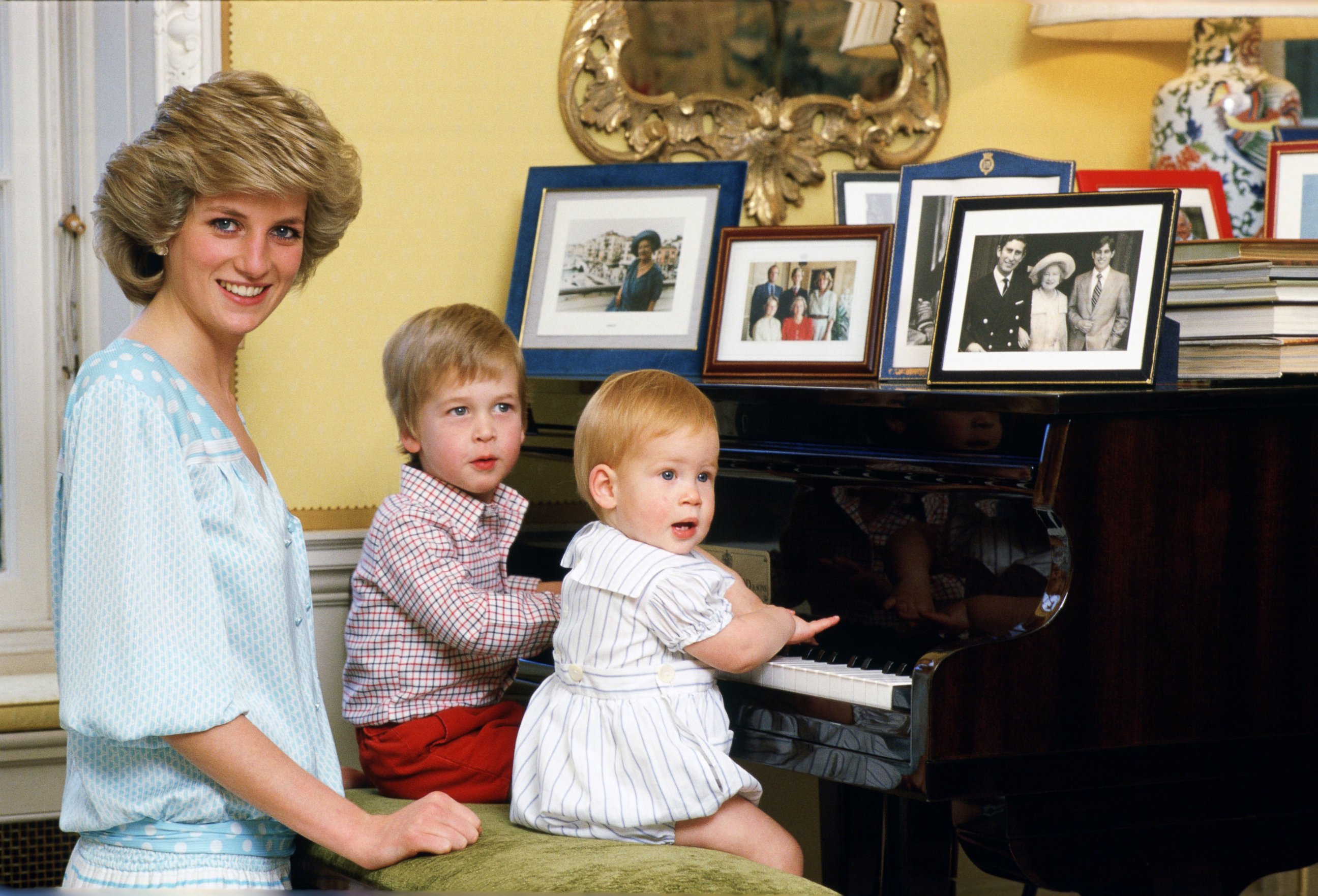 PHOTO: Diana, Princess of Wales with her sons, Prince William and Prince Harry, at the piano in Kensington Palace, Oct. 4, 1985, in the United Kingdom. 