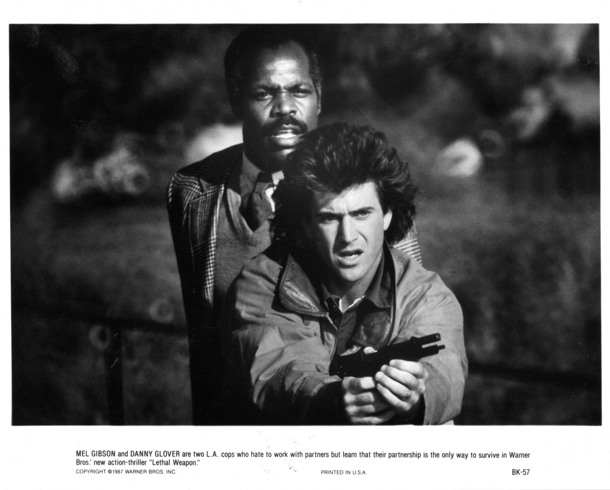 PHOTO: Danny Glover stands behind Mel Gibson in a scene from the film "Lethal Weapon," 1987. 