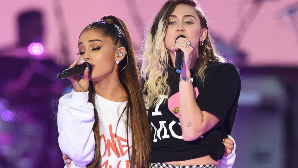 Ariana Grande, left, and Miley Cyrus perform on stage at the 'One Love Manchester' benefit concert, June 4, 2017 in Manchester, England.
