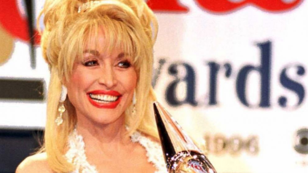 PHOTO: Dolly Parton stands with the award she won during the Country Music Awards, Oct. 2, 1996, at the Grand Ole Opry in Nashville.