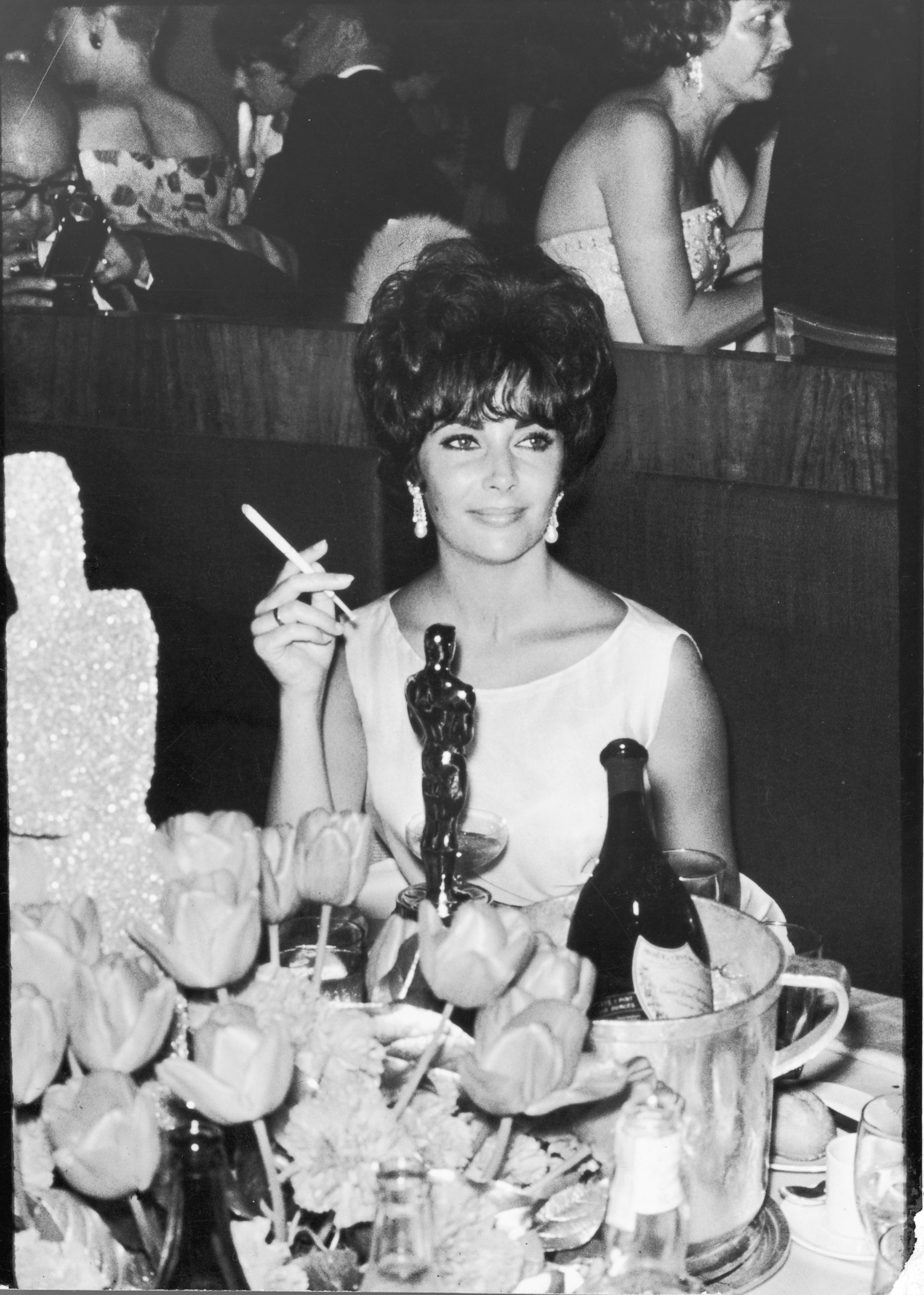 PHOTO: Elizabeth Taylor is pictured at a party in Hollywood, California, after winning an Oscar award, which is on table in front of her, circa 1961.   