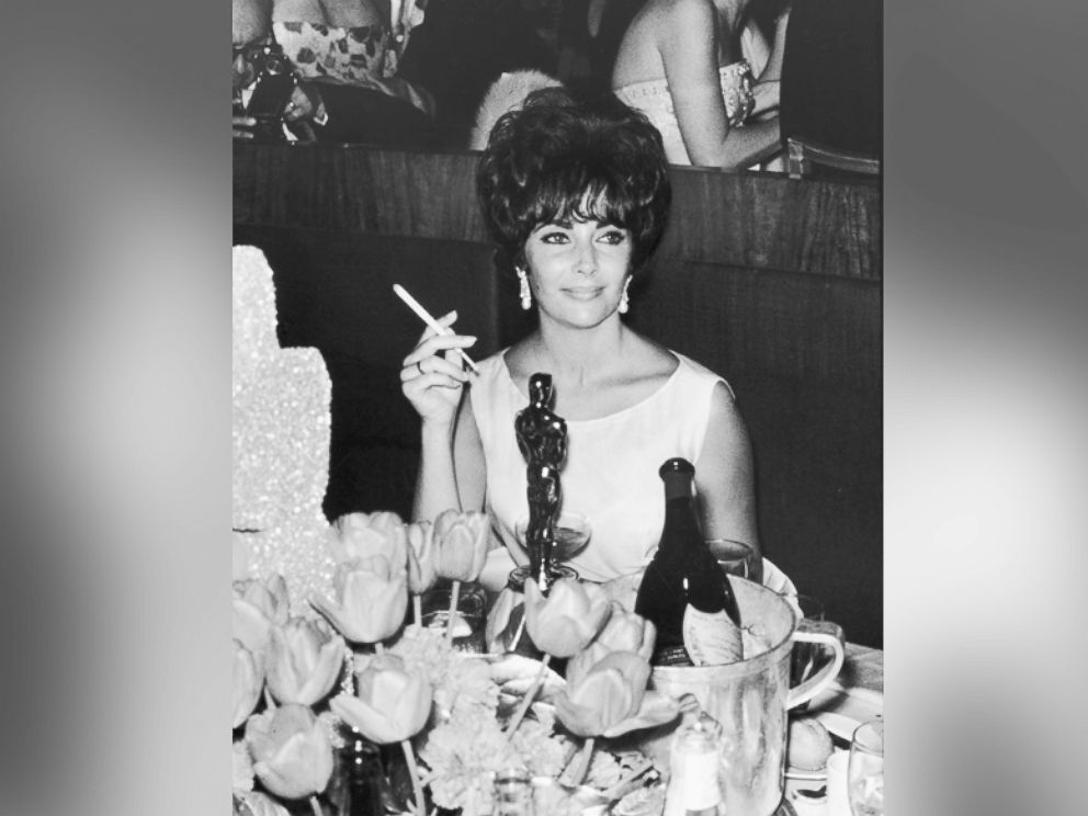 PHOTO: Elizabeth Taylor is pictured at a party in Hollywood, California, after winning an Oscar award, which is on table in front of her, circa 1961.
