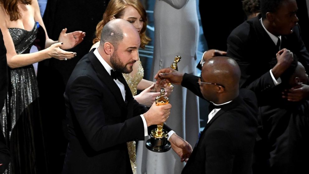 PHOTO: "La La Land" producer Jordan Horowitz hands over the Best Picture award to "Moonlight" writer/director Barry Jenkins following a presentation error onstage during the 89th Annual Academy Awards, Feb. 26, 2017, in Hollywood, California.