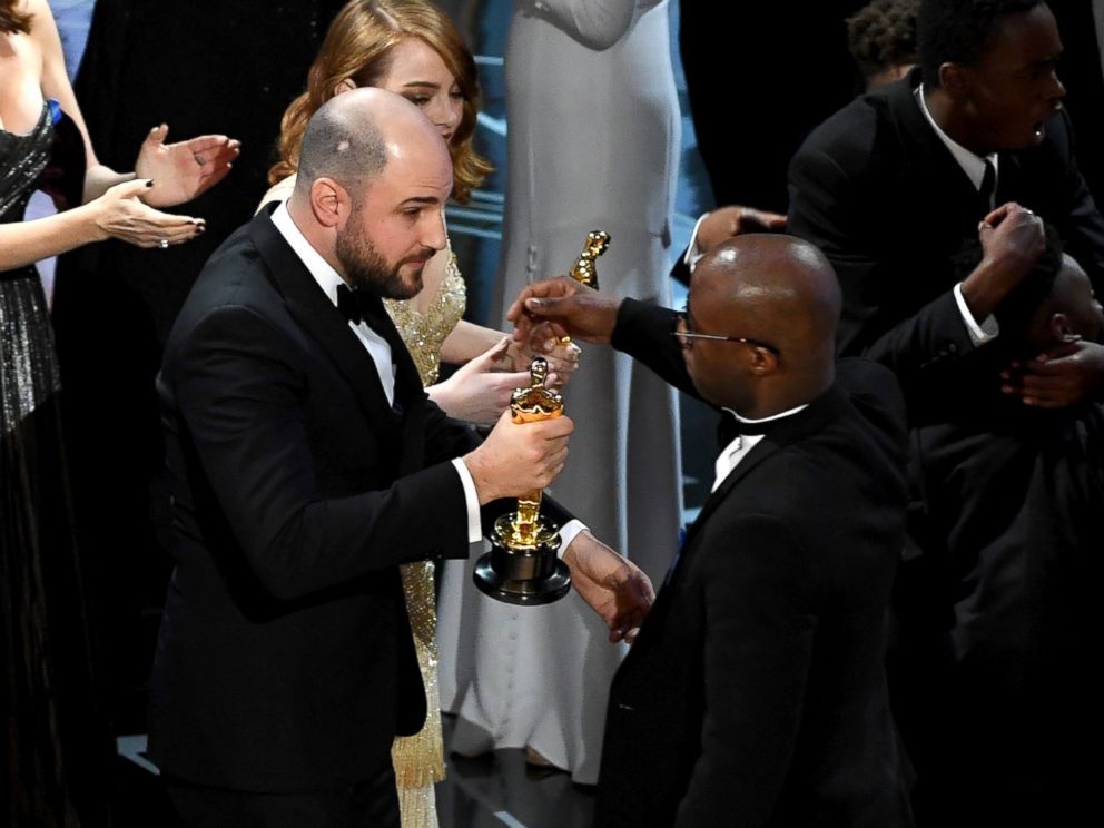 PHOTO: La La Land producer Jordan Horowitz hands over the Best Picture award to Moonlight writer/director Barry Jenkins following a presentation error onstage during the 89th Annual Academy Awards, Feb. 26, 2017, in Hollywood, California.