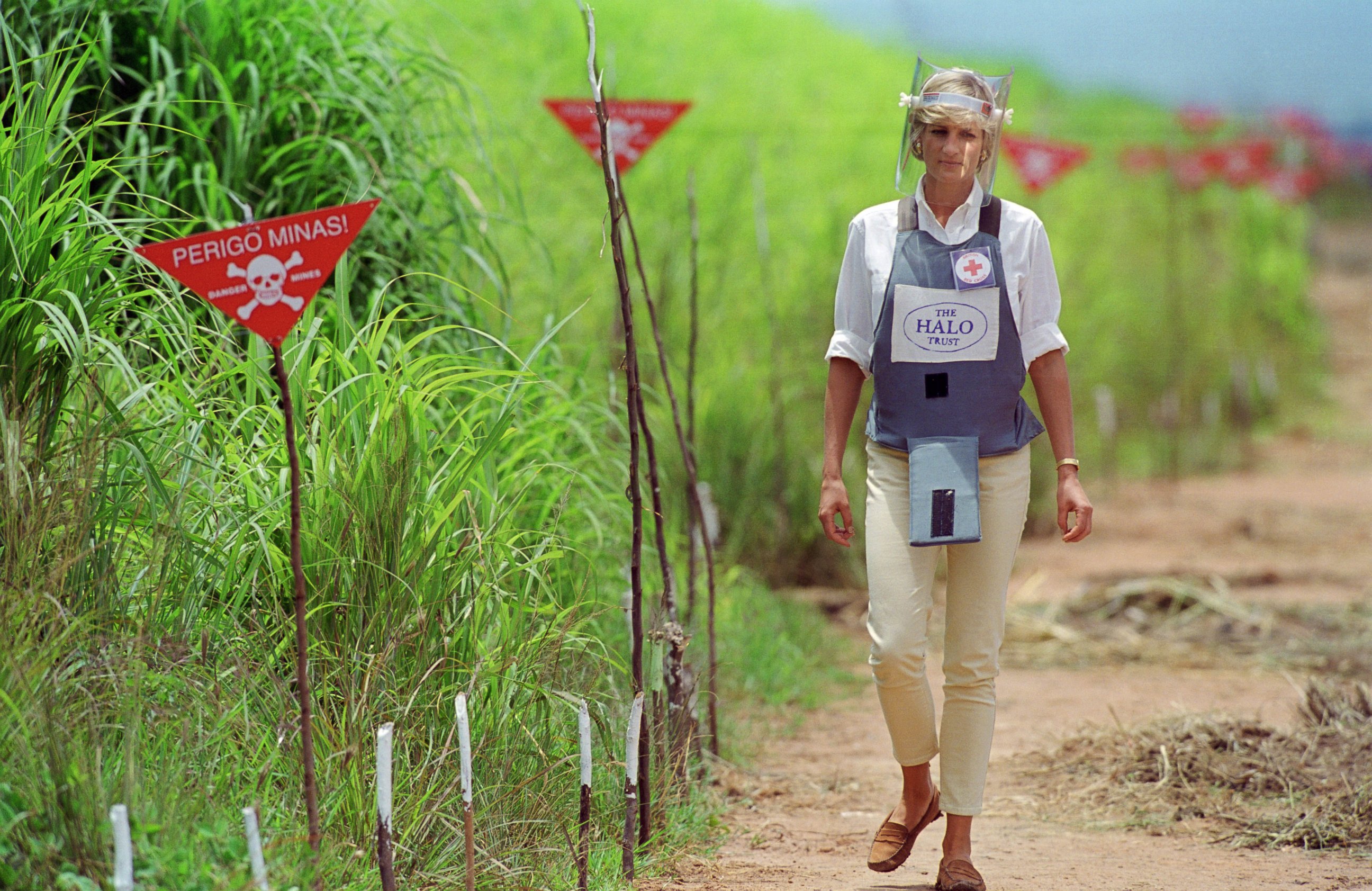 PHOTO: Diana, Princess of Wales wears protective body armor and a visor while visting a landmine minefield being cleared by the charity Halo in Huambo, Angola. 